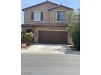 Charming two-story home features a well-manicured lawn, two-car garage and traditional architectural details at 5466 Scotch Cap Dr, Las Vegas, NV 89122