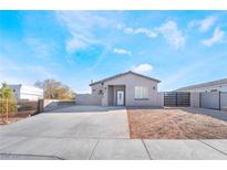 Charming single-story home featuring desert landscaping, a new driveway, and block wall fencing at 60 Pecos St, Las Vegas, NV 89110