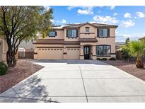 Charming two-story home featuring a three-car garage, landscaped yard, and inviting entrance at 623 Blue Snow River Ct, Henderson, NV 89002