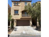 Charming two-story home with a balcony, a two-car garage, and inviting curb appeal at 7351 San Pablin St, Las Vegas, NV 89139