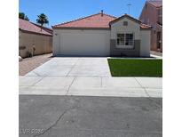 Charming single-story home featuring a well-manicured lawn, a two car garage and a red tile roof at 7957 Lovely Pine Pl, Las Vegas, NV 89143