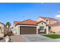 Charming single-story home featuring desert landscaping, a tile roof, and an attached two-car garage at 7957 Lovely Pine Pl, Las Vegas, NV 89143