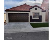 Charming single-story home with a red tile roof, two-car garage, and minimal landscaping at 7957 Lovely Pine Pl, Las Vegas, NV 89143