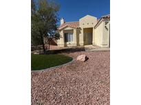 Well-maintained front yard features desert landscaping and a small, neat patch of green grass at 807 Airy Hill St, Henderson, NV 89015