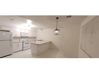 Bright kitchen featuring white cabinetry, granite counters, and modern appliances at 833 Hedge Way # 2, Las Vegas, NV 89110