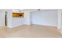 Bright living room with light colored wood flooring open to the kitchen at 8450 Alta Dr # 136, Las Vegas, NV 89145