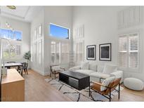 Bright living room featuring large windows with white shutters and modern furniture at 10729 Grey Havens Ct, Las Vegas, NV 89135