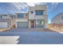 Modern two-story home with a neutral color palette, stone accents, and a two-car garage at 1321 Crimson Sunbird Ave, North Las Vegas, NV 89084