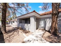 Charming home featuring a covered porch, beautiful landscaping, and a tile roof at 1838 N Jones Blvd, Las Vegas, NV 89108