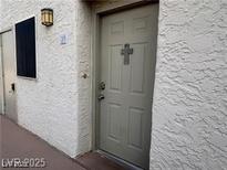 Condo front door with a cross on the door at 2064 Mesquite Ln # 304, Laughlin, NV 89029
