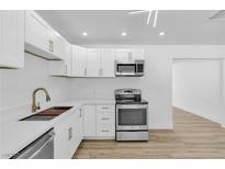 Bright kitchen features white cabinetry, stainless appliances, and quartz countertops at 2105 Berkley Ave, Las Vegas, NV 89101