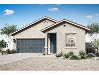 Charming single-story home featuring a two-car garage, desert landscaping, and a welcoming entrance at 3221 Walker River St, North Las Vegas, NV 89032