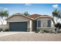 Charming single-story home featuring a two-car garage, desert landscaping, and a welcoming covered entry at 3233 Walker River St, North Las Vegas, NV 89032