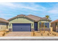 Charming single-story home featuring a tile roof, desert landscaping, and a two-car garage at 3233 Walker River St, North Las Vegas, NV 89032