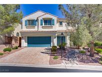 Charming two-story home with blue shutters, a well-manicured lawn, and a neatly paved driveway at 4012 Owlshead Mountain St, Las Vegas, NV 89129