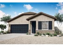 Charming single-story home with a two-car garage, neutral stucco, rock landscaping and a covered front porch at 4392 Cave Lake Ave, North Las Vegas, NV 89032