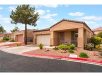 Inviting single-story home with attached garage, desert landscaping, and a charming front porch at 601 Bear Grass St, Las Vegas, NV 89144