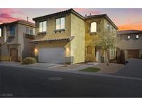Two-story home with a two-car garage, desert landscaping, and a charming entryway at 648 Sumatra Pl, Henderson, NV 89011
