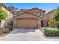 Charming two-story home with a two-car garage and desert landscaping for easy maintenance at 6625 Pine Siskin Pl, North Las Vegas, NV 89084