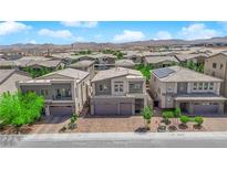 Beautiful home showcasing a modern two-story design and a paved driveway in a suburban neighborhood at 6643 Tangled Vines Ave, Las Vegas, NV 89139