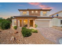 Charming two-story home featuring a brick-accented facade, covered porch, and a manicured front yard at 7931 Campers Village Ave, Las Vegas, NV 89178