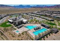 Stunning aerial view of resort-style pool and community amenities with mountain views in a vibrant residential area at 897 Woodburn Ln, Las Vegas, NV 89138