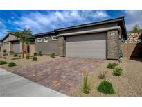 Charming single-story home with a brick driveway and stone accents at 897 Woodburn Ln, Las Vegas, NV 89138