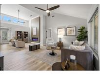 Bright living room featuring a modern fireplace, high ceilings, and an open concept design with neutral tones at 9540 Eagle Valley Dr, Las Vegas, NV 89134