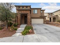 Charming two-story home featuring a stone accented entrance, desert landscaping, and a two car garage at 10373 Northern Hills Ave, Las Vegas, NV 89166
