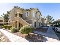 Inviting exterior showcasing a well-maintained two-story apartment building with beautiful landscaping and convenient parking spaces at 1550 Jamielinn Ln # 102, Las Vegas, NV 89110