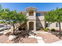 A condo building featuring a balcony and well-maintained landscaping at 1881 W Alexander Rd # 2079, North Las Vegas, NV 89032