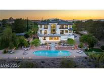 An expansive estate with a pristine pool and lush landscaping, perfect for luxurious outdoor living and entertaining at 22 Anthem Pointe Ct, Henderson, NV 89052