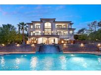 An opulent residence with a stunning pool and waterfall feature provides a luxurious outdoor experience at 22 Anthem Pointe Ct, Henderson, NV 89052