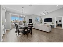 Bright living area with a dining table, couch, and balcony access, providing seamless indoor-outdoor living at 2325 Windmill Pkwy # 1124, Henderson, NV 89074
