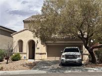 Charming single-Gathering home features stucco exterior, desert landscaping, and attached two-car garage at 2620 Galimard Ter, Henderson, NV 89044