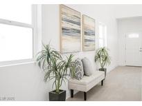 Inviting entryway featuring a bench, plants, and modern art for a stylish first impression at 3915 Wesvan Ct, Las Vegas, NV 89121