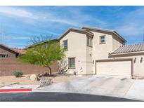 Inviting two-story home featuring a two-car garage, stucco facade, and xeriscaped front yard at 4014 Sparrow Rock St, Las Vegas, NV 89129
