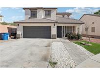 Charming two-story home featuring a two-car garage, well-maintained landscaping, and a welcoming entrance at 5220 Remini Ct, Las Vegas, NV 89130