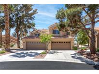 Charming two-story home featuring a spacious three-car garage and a beautifully landscaped front yard with mature trees at 5329 La Patera Ln, Las Vegas, NV 89149