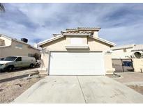 Charming single-story home featuring a wide two-car garage and a well-maintained front yard at 5720 Ruby Creek Dr, Las Vegas, NV 89142