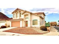 Charming two-story home features a well-kept front yard and attached two-car garage at 66 John Stuart Mill St, Henderson, NV 89002