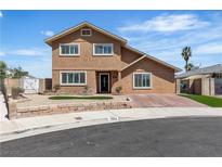 Charming two-story home featuring a well-maintained front yard and welcoming entrance at 7604 Charles Conrad Cir, Las Vegas, NV 89145