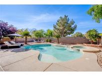 Beautiful backyard pool and spa with lounge chairs, landscaping, and unobstructed view in a luxury home at 8321 Gorsky Ave, Las Vegas, NV 89131