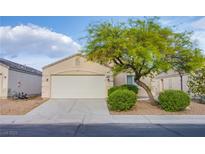 Charming single-story home featuring a two-car garage, desert landscaping, and mature shade tree at , Las Vegas, NV 89130