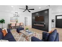 Cozy living room boasts fireplace, ceiling fan, and seamlessly connects to the dining area at 1020 Baker Ave, Las Vegas, NV 89108