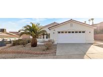 Charming single-story home with a two-car garage and desert landscaping in front at 116 Crescent Bay St, Henderson, NV 89012