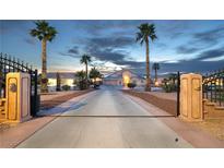 Gated estate home with long driveway and desert landscaping under a dusky sky at 1259 N Hollywood Blvd, Las Vegas, NV 89110