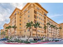 Elegant multi-story building showcasing its architectural design, landscaping, and surrounding palm trees at 2405 W Serene Ave # 703, Las Vegas, NV 89123