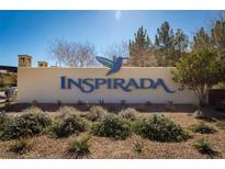 Community sign reading Inspirada set amongst desert landscaping under a clear blue sky at 3166 Via Da Vinci, Henderson, NV 89044