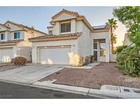 Charming two-story home featuring a two-car garage, desert landscaping, and a warm, inviting entrance at 3525 Tuscany Village Dr, Las Vegas, NV 89129
